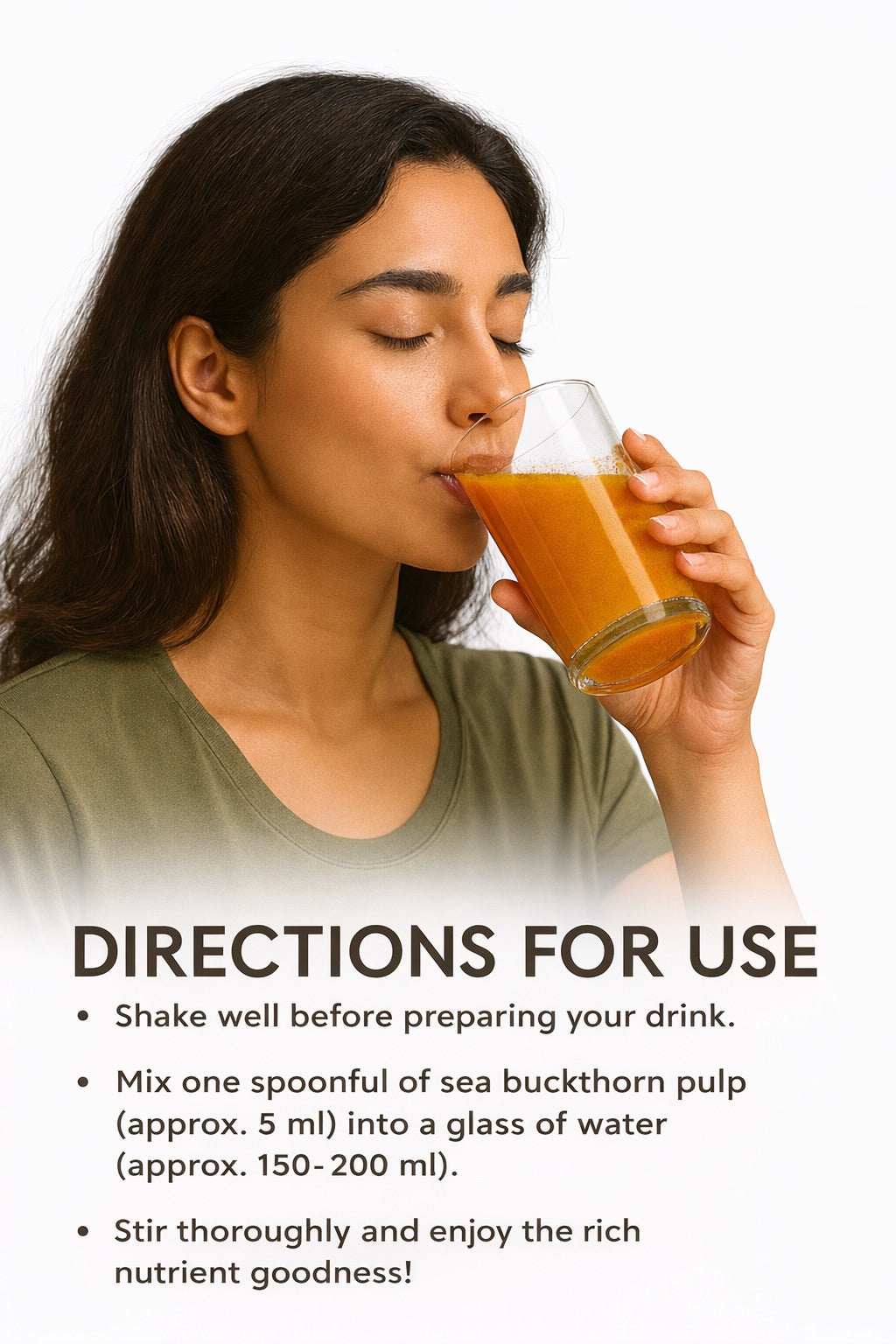 A woman drinks a glass of sea buckthorn juice.